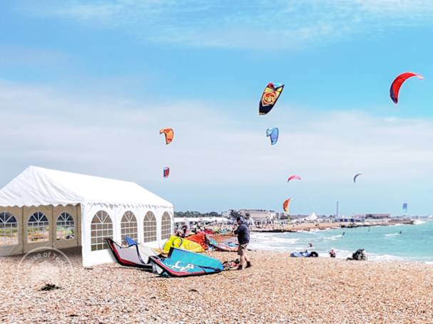 Marquee as sheltered base for kite surfers