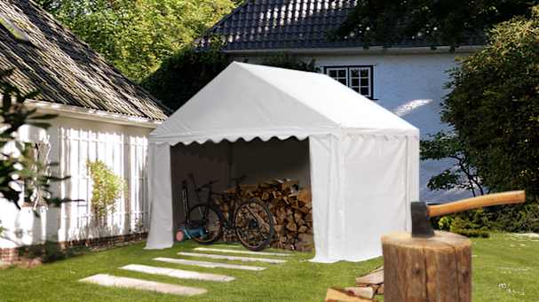 Wood stack piled underneath a storage tent