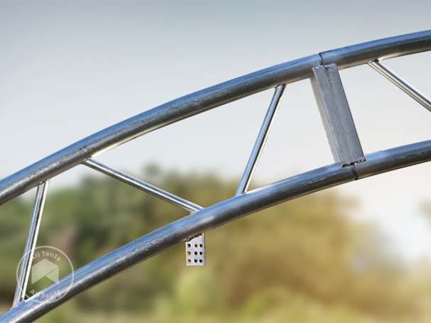 Close-up of a double-truss steel arch frame with crossbars for fabric shelters