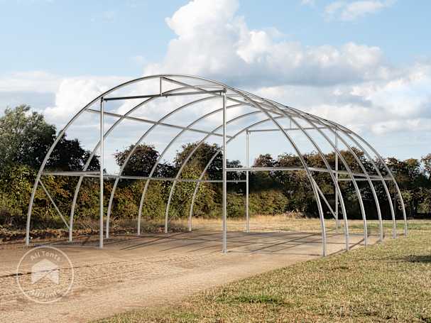 Steel frame structure of an arched shelter on open ground
