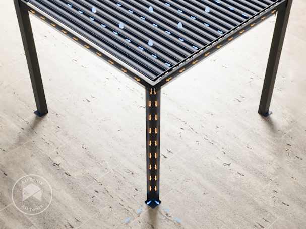 image showing how rainwated is channeled through the louvered pergolas integrated guttering system