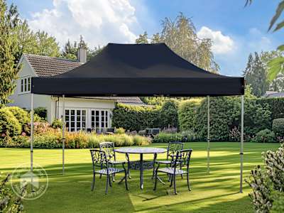 Portable 3x4.5 black pop up gazebo providing shade over garden dining area