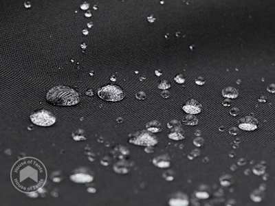 Close-up of lightweight PES tarpaulin with water droplets on the surface, showing water-repellent finish