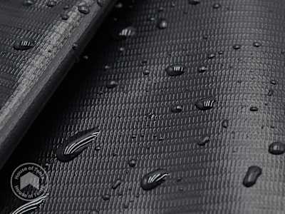 Durable PVC tarpaulin with water droplets on a textured truck-tarpaulin-style surface