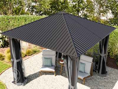 aerial view of a solid steel garden gazebo in a garden patio with furniture under it