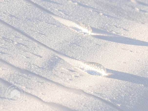 Close-up of water droplets on waterproof 3x6 gazebo tarpaulin showing water-repellent surface.