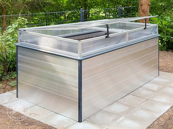 a raised garden bed with a cold frame topper