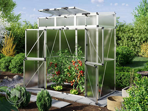 a small tomato greenhouse with tomato plants inside in the middle of a garden